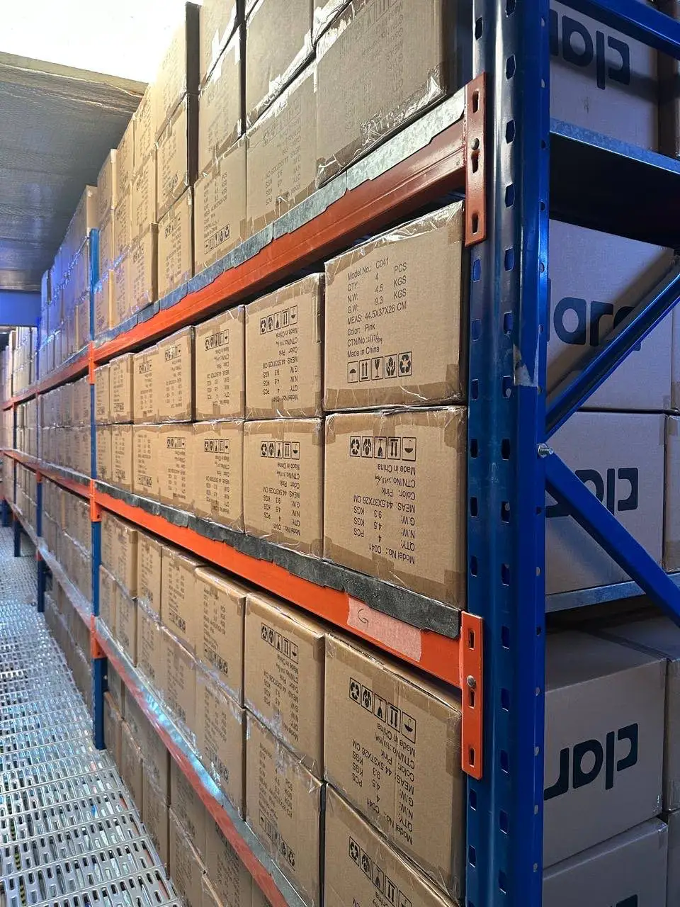 Boxed fragrance stock on shelving in a Dubai warehouse