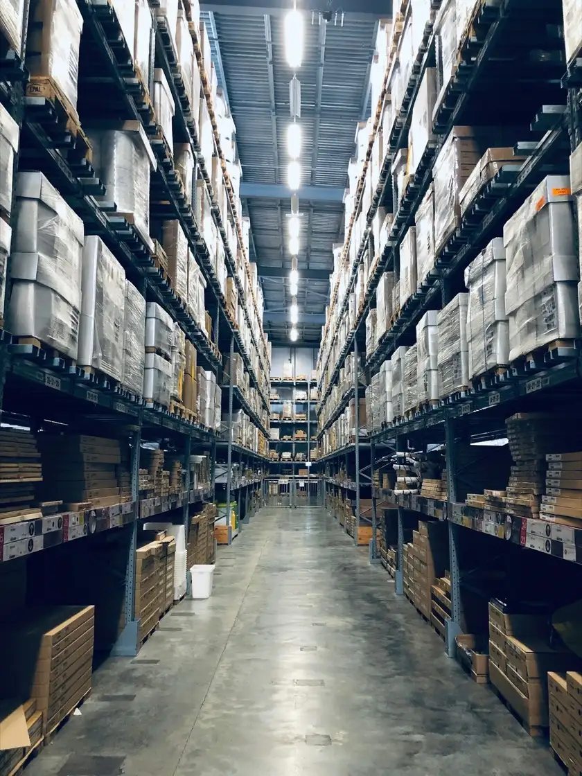 High-bay racking aisle stocked with boxed ecommerce inventory in a Dubai warehouse